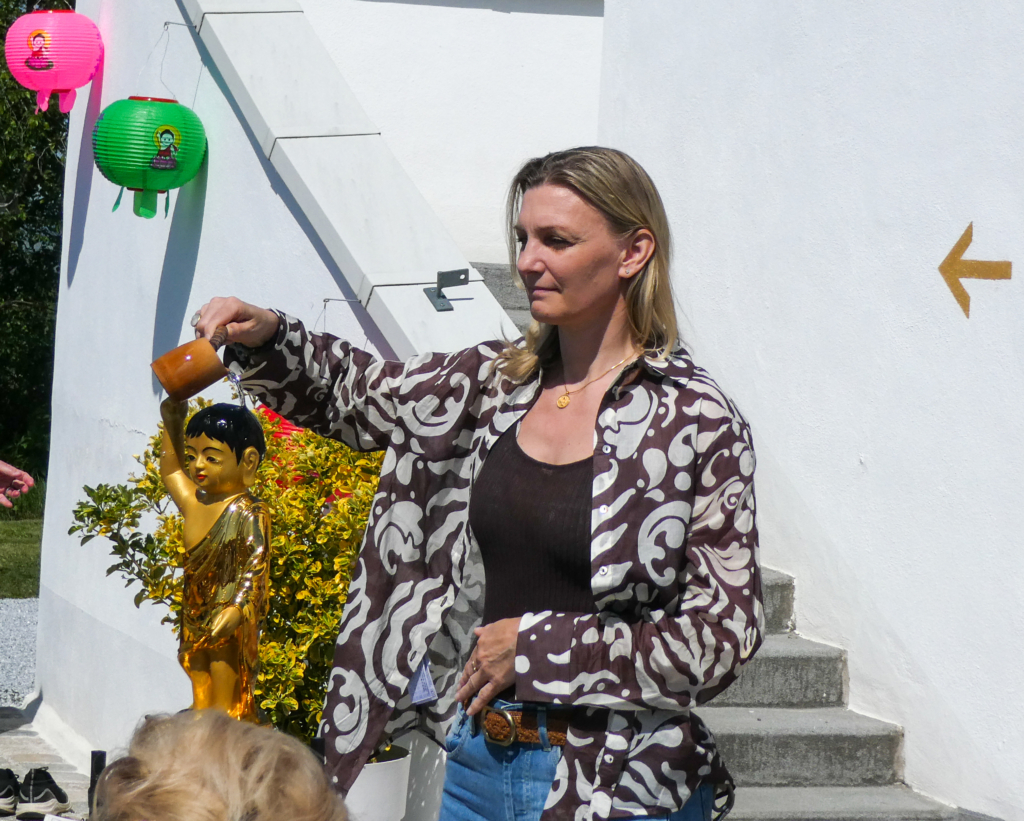 Mag. Barbara Riedl gießt Wasser auf den kleinen Buddha